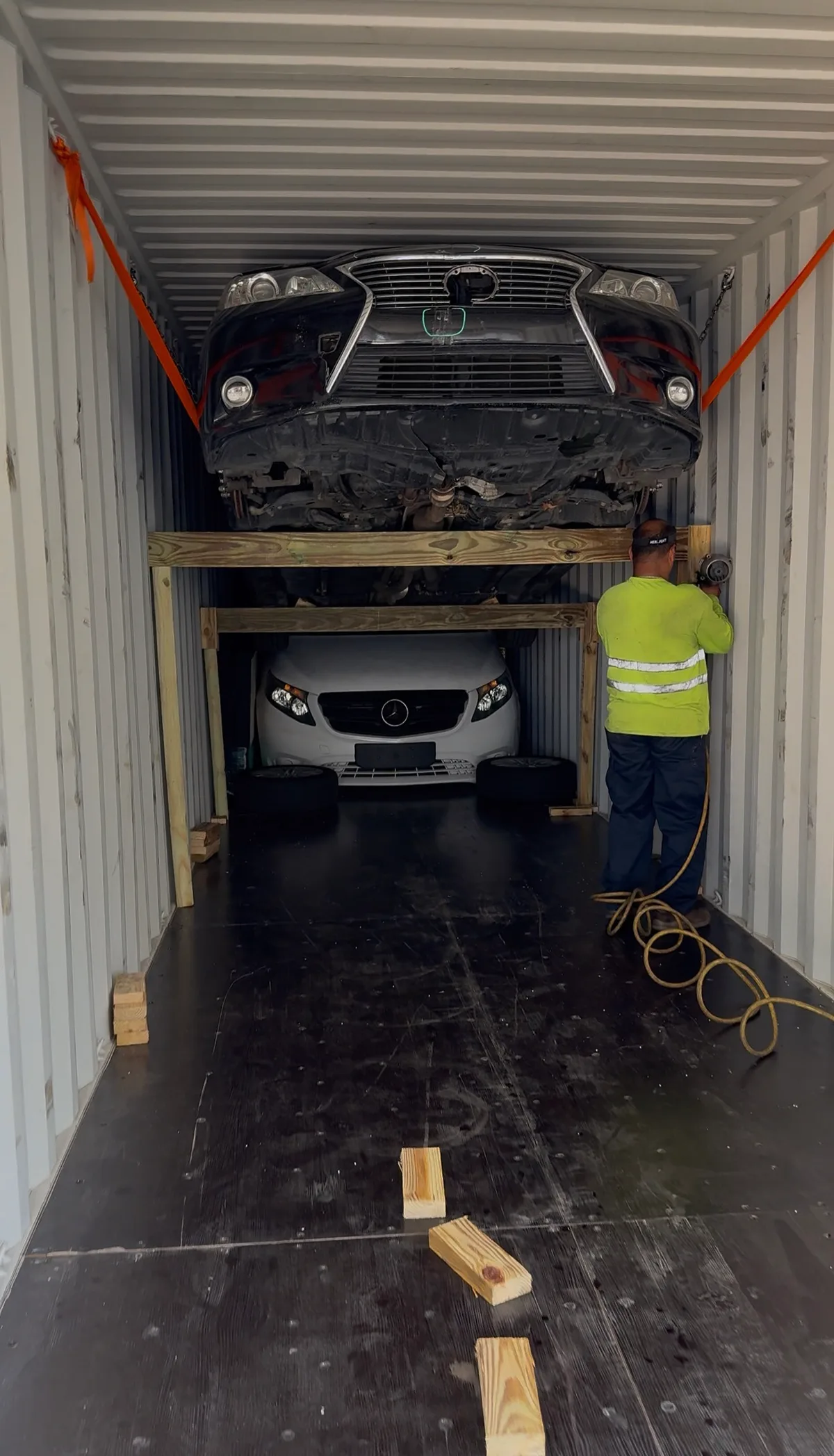 Vehicles secured and stacked inside a shipping container
