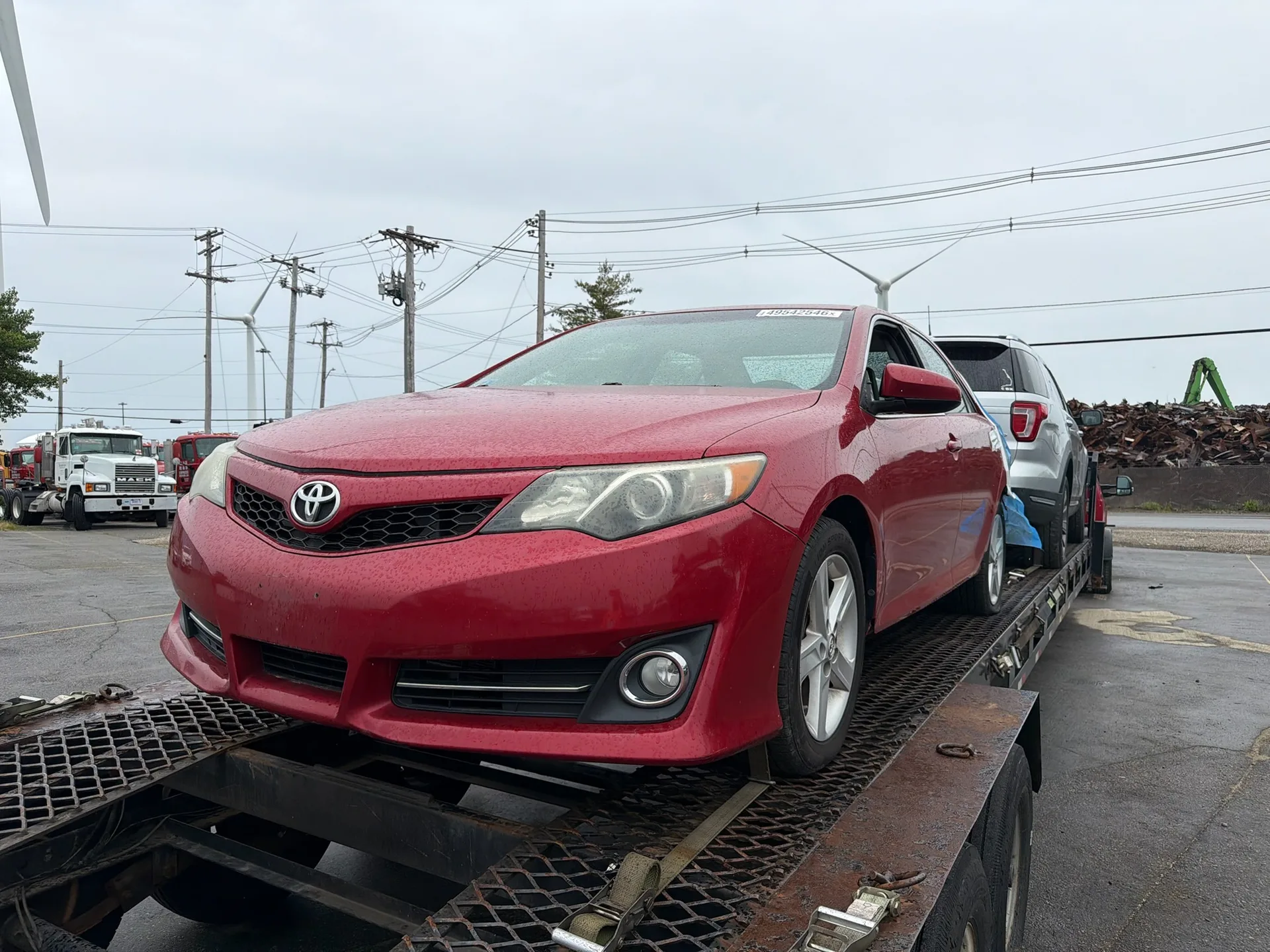 Sedan secured on carrier for port delivery